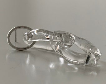 May include: A clear glass earring with a unique, twisted design. The earring is attached to a silver post.