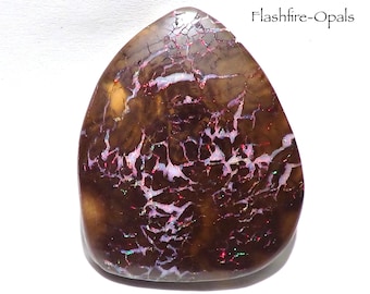 195 ct. Double matrix gem opal. Luminous red/green-blue veins