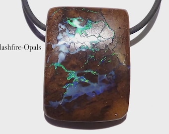 May include: A rectangular pendant with a brown base color, featuring vibrant green and blue opal patterns. The pendant is suspended from a black cord. The text "Flashfire-Opals" is visible on the left side.