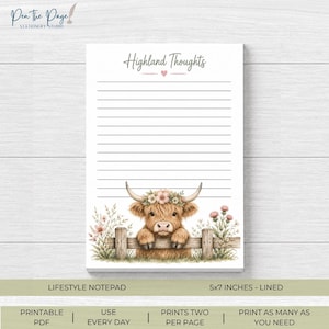May include: A white lined notepad titled Highland Thoughts with a small pink heart. The bottom features a brown Highland cow with a floral crown resting its front hooves on a wooden fence, surrounded by pink and green wildflowers on both sides.