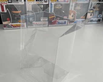 May include: A clear, rectangular plastic protective display case for a collectible figure box. The case is constructed from thin, transparent material with folded edges and an open top flap, designed to fit standard square-shaped toy packaging.