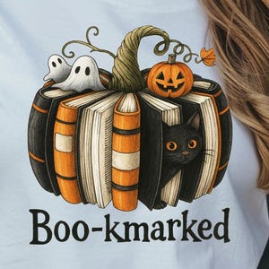 May include: White t-shirt with a Halloween design. The design shows a pumpkin made of books, a black cat, ghosts, and a jack-o'-lantern. The text "Boo-kmarked" is below the design. The bottom of the shirt has the text "Swank PRINTABLES".