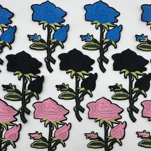 May include: Embroidered rose patches in blue, black, and pink. Each patch features a detailed rose with green leaves and stems. The patches are ideal for adding a floral touch to clothing or accessories.
