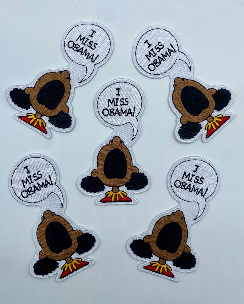 May include: Six white iron-on patches with a cartoon image of a Black girl with her mouth open and the text "I Miss Obama!" in a speech bubble above her head.