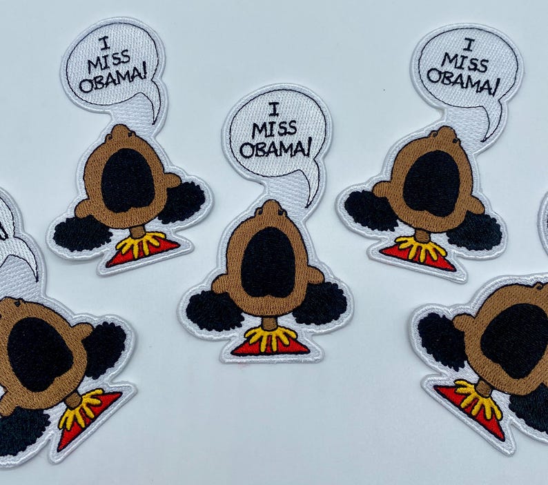 May include: Five embroidered iron-on patches featuring a cartoon character with an open mouth and the text "I Miss Obama!" above the character.