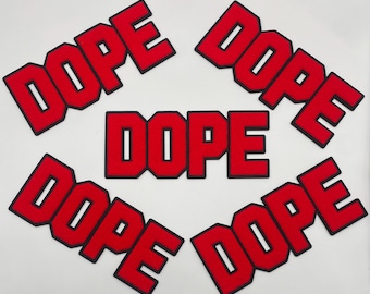 May include: Red embroidered patches featuring the word "DOPE" in a bold, block letter font. Each patch has a black border, and the word is centered on a white background. The patches are arranged in a circular pattern.
