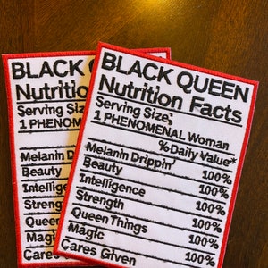 May include: Two red and white embroidered patches with the text "Black Queen Nutrition Facts" and a list of qualities with percentages. The qualities listed are "Melanin Drippin', Beauty, Intelligence, Strength, Queen Things, Magic, Cares Given".