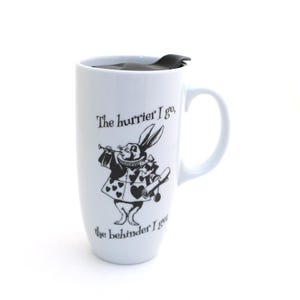 May include: A tall white ceramic travel mug with a black lid and a handle. The front features a black line-art illustration of a rabbit wearing a ruffled collar and a jacket with heart patterns, holding a scroll. Text reads: The hurrier I go, the behinder I get.