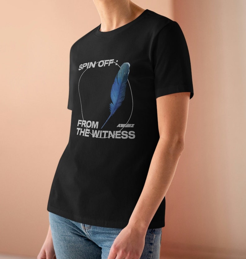 May include: Black t-shirt with a white graphic design featuring a blue feather and the text "SPIN OFF: FROM THE WITNESS" with the band name "ATEEZ" in smaller font.