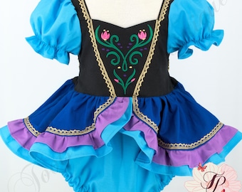 May include: A black bodice dress with bright blue puff sleeves and a multi-layered skirt featuring dark blue, purple, and light blue ruffles. The black bodice displays a green floral embroidery with pink accents and gold trim along the neckline.