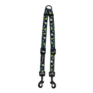 May include: A navy blue double dog lead with a pear and floral pattern. The lead has black metal clips and adjustable buckles. The text "The Oddly Dog" is printed on the lead.