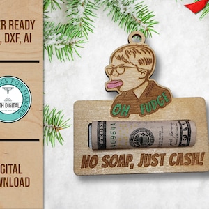 May include: Wooden Christmas ornament featuring a cartoon character with the text "OH FUDGE" and "NO SOAP, JUST CASH!". The ornament holds a rolled-up dollar bill. The design is laser-ready and available in SVG, DXF, and AI formats.