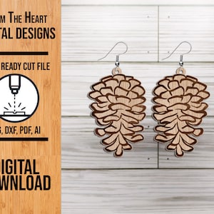 May include: A pair of laser cut wooden earrings shaped like pine cones. The earrings are brown and have a natural wood finish. The earrings are hanging from silver hooks.