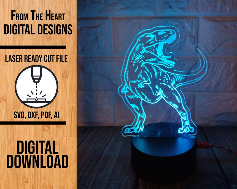 May include: A glowing blue Tyrannosaurus Rex dinosaur lamp. The lamp is a laser-cut design, with the text "FROM THE HEART DIGITAL DESIGNS" and "DIGITAL DOWNLOAD" visible. The lamp is on a black base.