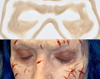 Puede incluir: Un molde de silicona para crear heridas de aspecto realista. El molde tiene forma de rostro humano y presenta arrugas y líneas detalladas. El molde está diseñado para ser utilizado con maquillaje y efectos especiales.