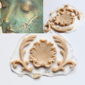 May include: A silicone mold for making decorative cake toppers or other crafts. The mold features a large shell design with two smaller floral designs on either side.