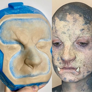 Peut inclure: Gros plan d'un moule en silicone pour un visage prothétique. Le moule est bleu et présente une impression détaillée d'un visage avec un grand nez et des pommettes saillantes.