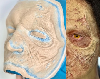 May include: A close-up of a zombie makeup mold and the finished makeup effect. The mold is made of silicone and has a detailed texture. The finished makeup is realistic and gruesome, with a pale yellow color and deep wrinkles.