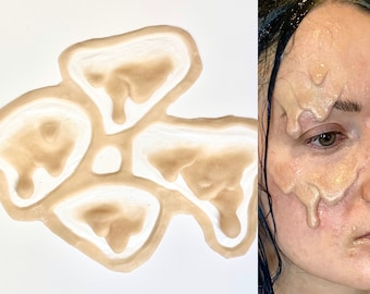 May include: Five silicone molds in the shape of dripping goo, arranged in a flower shape. The molds are beige and have a smooth, glossy finish.
