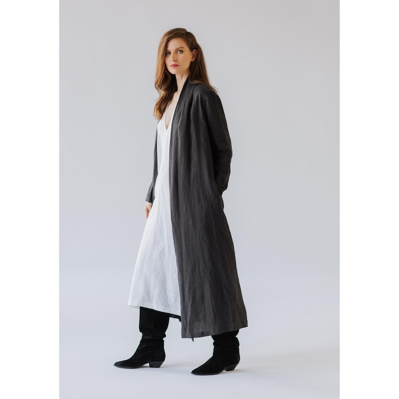 Artisan-crafted long linen jacket, designed in Latvia, shown on model for scale and fit reference.