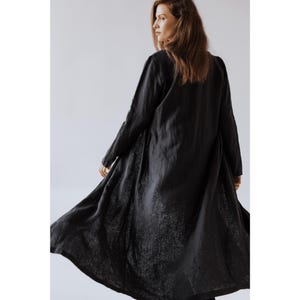 Minimalist women's linen jacket with discreet pockets and clean lines, styled over casual attire.