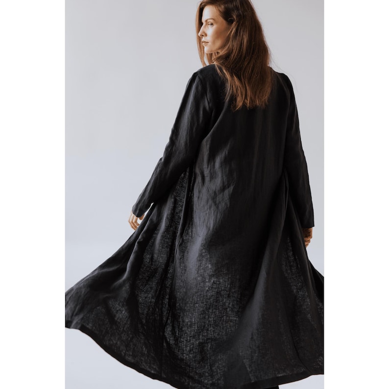 Minimalist women's linen jacket with discreet pockets and clean lines, styled over casual attire.