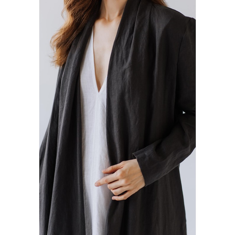 Close-up of linen fabric texture and discreet pocket detail on a sustainable women's jacket.