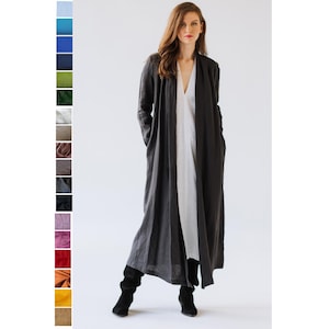 Model wearing a long neutral-tone linen jacket with a relaxed fit, handmade from 100% Oeko-Tex certified linen.