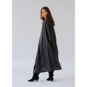 Full-length linen coat for women, breathable and sustainably made, photographed in natural light.