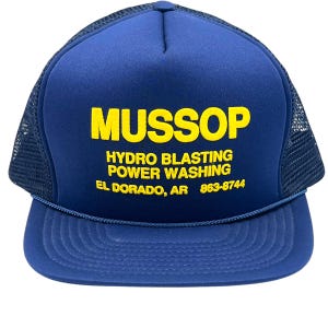 May include: A blue trucker hat with a yellow embroidered logo that reads "MussoP Hydro Blasting Power Washing El Dorado, AR 863-8744".