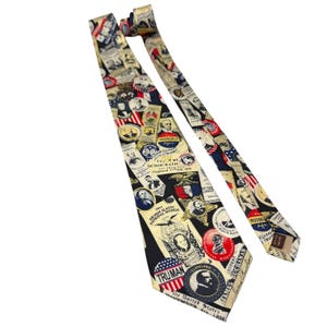 May include: A necktie featuring a cream-colored background with a repeating pattern of vintage American political campaign buttons, portraits of presidents, and historical text including names like Truman, Roosevelt, and James Buchanan.