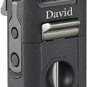 May include: A black lighter with the name "David" engraved on the front. The lighter has a textured surface and a silver-coloured metal accent. Blue flames are visible emanating from the top.