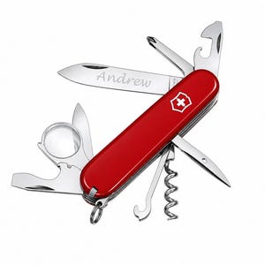 May include: A red multi-tool pocket knife featuring a stainless steel blade engraved with the name Andrew. The tool includes a magnifying glass, corkscrew, bottle opener, screwdriver, and a small metal ring attached to the end of the handle.