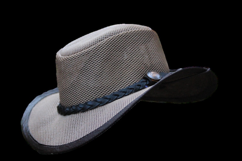 May include: A tan mesh hat with a dark brown brim and a decorative braided band. The hat features a small, round metal accent on the side. The hat is designed for outdoor wear.