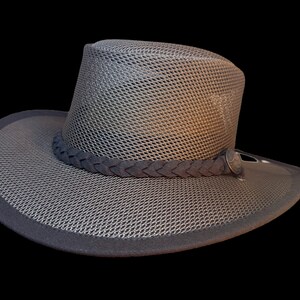 May include: A gray mesh hat with a dark gray braided band and a dark gray brim. The hat has a structured crown and a wide brim. The hat is designed for sun protection and outdoor activities.