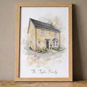 May include: A framed watercolour painting of a detached house with a yellow facade and a black roof. The artwork features a small garden and is inscribed with "The Taylor Family". The frame is made of light wood.