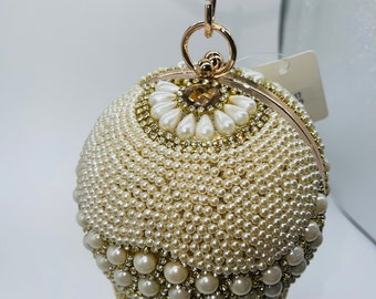 round gold clutch bag