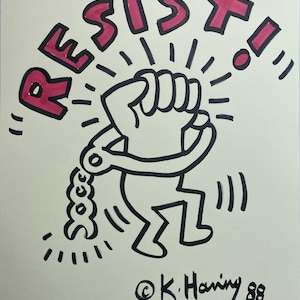 May include: Illustration of a figure breaking free from shackles, with the word "RESIST!" in pink letters. The artwork is signed "@K. Haring 88".