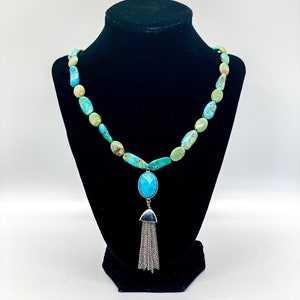 Green and blue turquoise necklace with decorative silver clasp