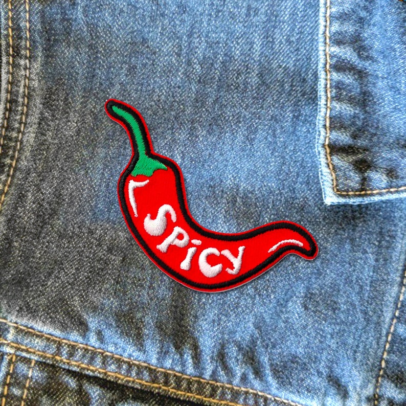May include: Red chilli pepper embroidered patch with the word "SPICY" in white lettering. The patch is iron-on and can be used to decorate clothing, bags, or other items.