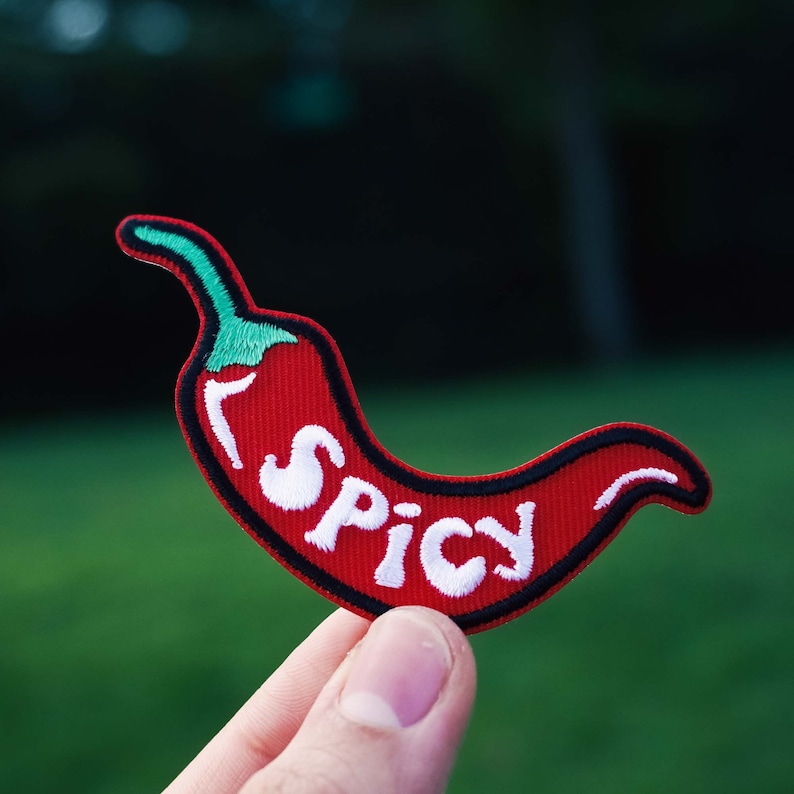 May include: Red chili pepper patch with white embroidery that says "Spicy".