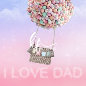 May include: A hot air balloon made of pastel colored balloons with a wicker basket and the words "I LOVE DAD" written in clouds against a pink and purple gradient background.