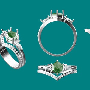 May include: A silver ring set with a green gemstone and smaller diamonds. The ring is designed with a V-shaped band and a prong setting for the center stone.