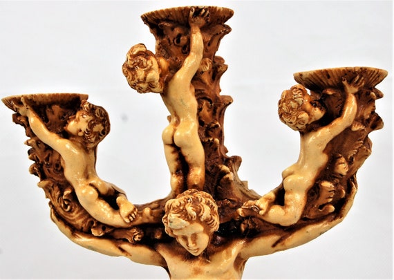 Shabby Chic candlestick with an elaborate design by cherubs