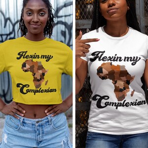 May include: Two women wearing t-shirts with a graphic of the continent of Africa. The text on the shirts reads "Flexin my Complexion".