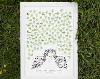 May include: A white framed print with a black and white illustration of a wedding ceremony with a green fingerprint guest book. The text "CONSTANCE & MATHIAS 31 MAI 2025" is at the bottom of the print.