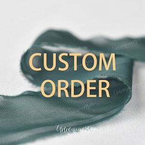 May include: A teal blue fabric ribbon with the text "CUSTOM ORDER" in yellow letters.
