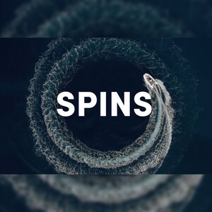 May include: Aerial view of a speedboat creating a circular wake in dark blue water. The word "SPINS" is written in large white letters across the image, emphasizing the boat's action.