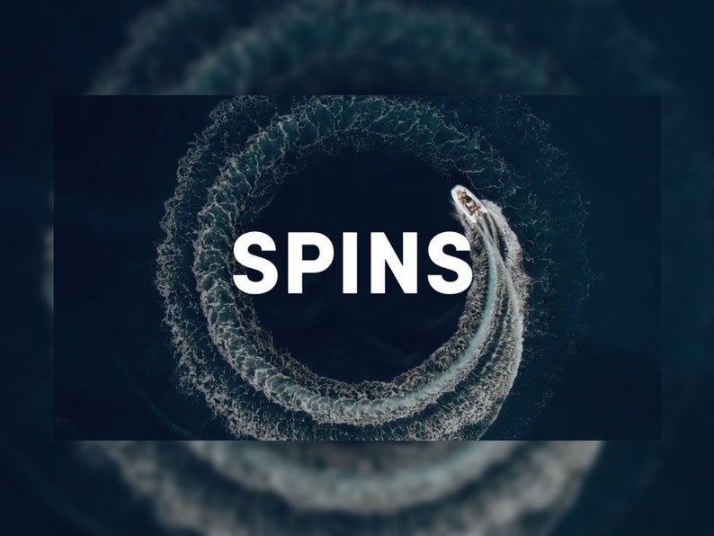 May include: Aerial view of a speedboat creating a circular wake in dark blue water. The word "SPINS" is written in large white letters across the image, emphasizing the boat's action.
