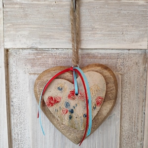 Heart meets wood, ceramic heart on wooden heart, gift,